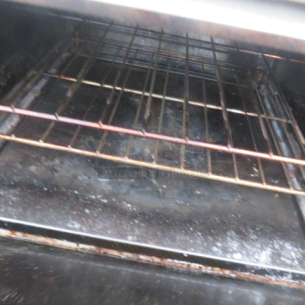 Southbend 10 burner natural gas range with 4 racks, stainless steel over shelf, on casters, dimensions 60.5x34x60 inches.