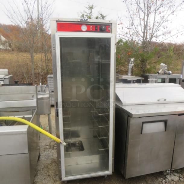 Vulcan Heat and Hold cabinet on casters, 25x30x71 inches, stainless steel, glass door, visible temperature gauge, used condition.