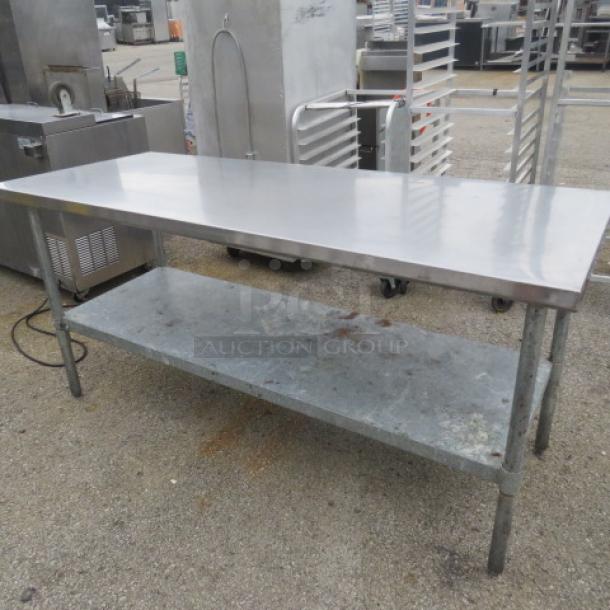 Stainless steel table with under shelf, 72x30x35 inches, in used condition.