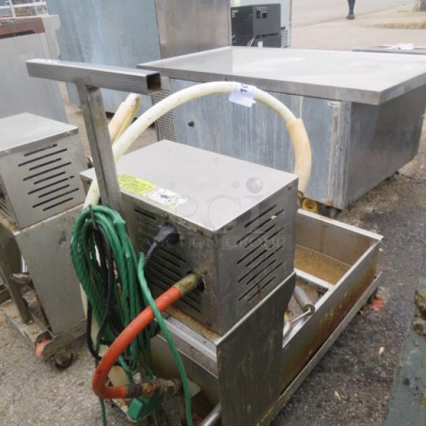 One 96lb oil filtration system, Model 405, on casters, 120V, showing hoses and power cords, used condition.