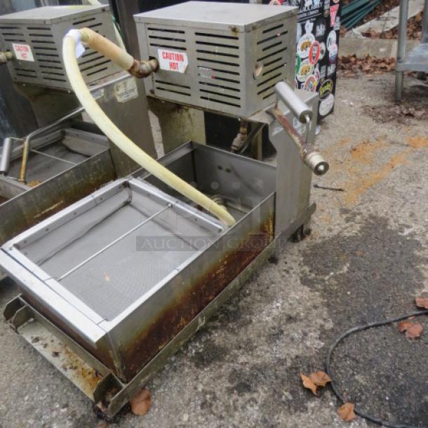 One 96lb oil filtration system on casters, Model 405, 120V. Features include hose attachment and caution markings. Used condition.