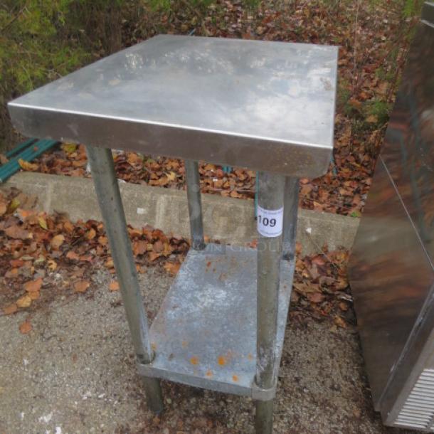 Stainless steel table with under shelf, measures 24x18x34 inches. Used condition, item number 109 visible.