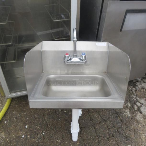 Stainless steel hand sink with faucet, side splashes, and backsplash. Size 7x6. Includes R/L handles. Good condition.