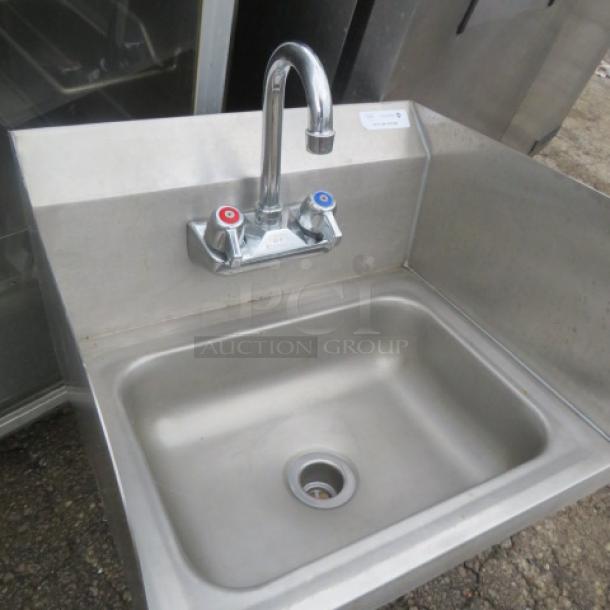Stainless steel hand sink with faucet, red/blue knobs, R/L and backsplash, 7x6. Excellent condition.