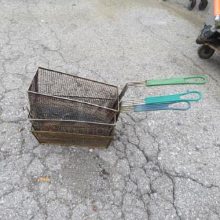 Assorted fry baskets, three pieces, metal mesh with green handles, used condition, ideal for commercial kitchen use.