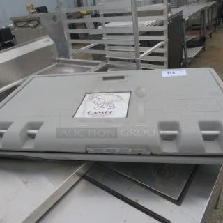Gamco wall mount baby changing station, light gray, closed, sturdy plastic, visible logo, in used condition.