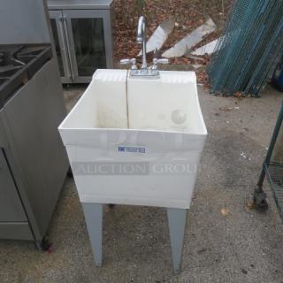 White utility sink with faucet, 19x24x44 inches, on metal legs. Appears used, with visible wear and dirt. Brand label on front.