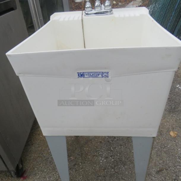 White utility sink with faucet, dimensions 19x24x44 inches, VITAFLO brand label, on gray legs, lightly used condition.