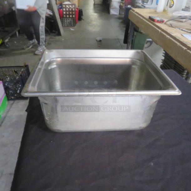 Half size 6-inch deep hotel pan, stainless steel, good condition, ideal for commercial kitchen use.