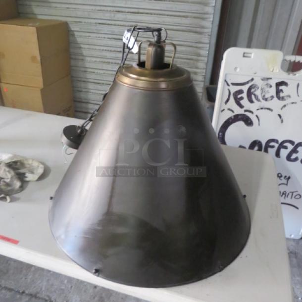 Industrial-style metal pendant light, model #E-229506, conical shape, bronze finish, in excellent condition.