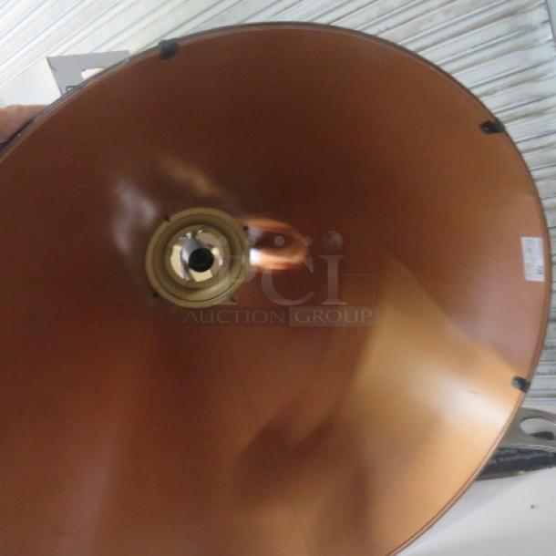 Metal pendant light with copper finish, sleek dome shape, and central bulb socket. Item #E-229506. Tags visible.