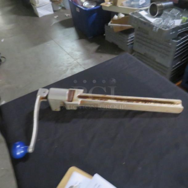 Edlund 10lb can opener, manual operation, metal construction with blue handle, visible wear, suitable for industrial use.