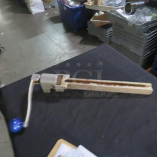 Edlund 10lb can opener, manual operation, metal construction with blue handle, visible wear, suitable for industrial use.