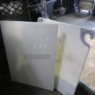 Assorted cutting boards, two pieces, 15x20 inches, white with decorative edges, in used condition.