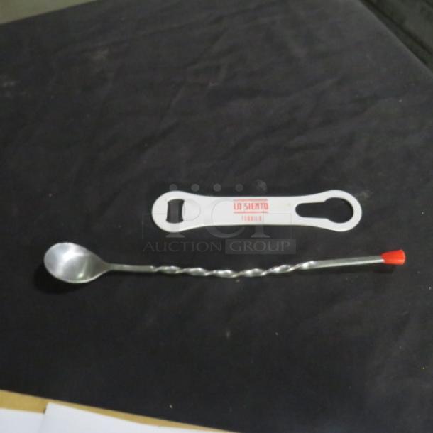 Assorted bar utensils featuring a twisted cocktail spoon with a red tip and a white bottle opener labeled "Lo Siento Tequila."