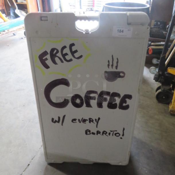 Sidewalk sign, 26x43 inches, white with handwritten "Free Coffee w/ every Burrito!" message, shows slight wear.