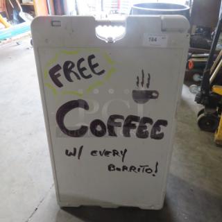 Sidewalk sign, 26x43 inches, white with handwritten "Free Coffee w/ every Burrito!" message, shows slight wear.