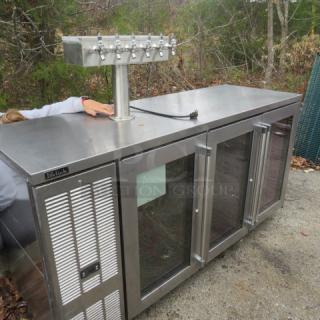 Perlick glass door kegorator, Model BBSN-72-RO-1, with one tower, six taps, on casters, 115V; labeled with logo.