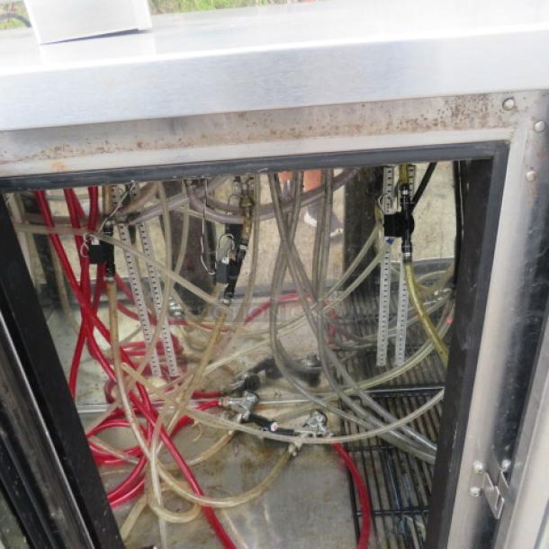 Perlick glass door kegorator with one tower, six taps, visible hoses. Model BBSN-72-RO-1, on casters, 115V. Used condition.