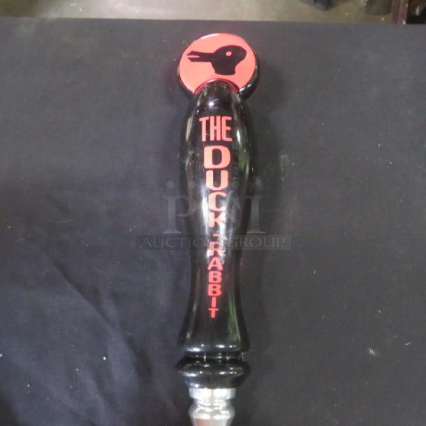 The Duck-Rabbit beer tap handle, black with red text and logo, in good condition.