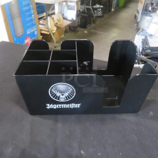 Black Jägermeister bar organizer with multiple compartments, logo on front. Ideal for bar use, in good condition.