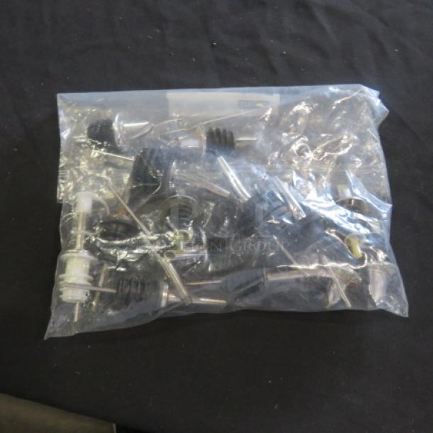Bag of assorted pourers in good condition, featuring various metal spouts and rubber stoppers, ideal for bar use.
