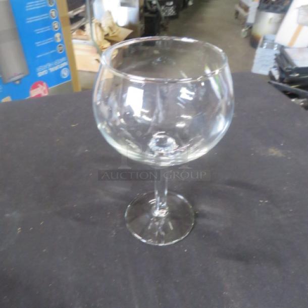 Clear stem wine glass, model 9XBID, with a wide bowl and sleek stem. Appears in excellent condition.