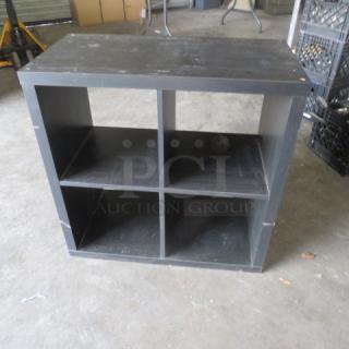 Black wooden shelving system with four compartments, measuring 30x15x30 inches. Shows signs of wear.