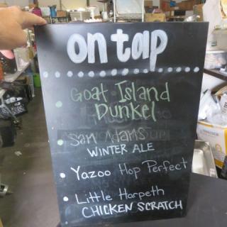Black metal beer sign, 14x20.5 inches, featuring "On Tap" and listings for Goat Island Dunkel, Sam Adams Winter Ale, Yazoo Hop Perfect, Little Harpeth Chicken Scratch. Used condition.