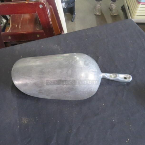 85oz aluminum scoop, used condition, visible surface wear, sturdy handle with two rivets, ideal for bulk scooping.