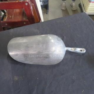 85oz aluminum scoop, used condition, visible surface wear, sturdy handle with two rivets, ideal for bulk scooping.