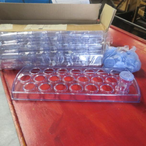 New Camel Horaca shot glass holder with 50 shot glasses and lids, on a red surface, showing packaging and contents.