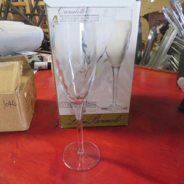 New 7oz blown crystal champagne flute against box, featuring Luigi Bormioli branding. Elegant design, pristine condition.