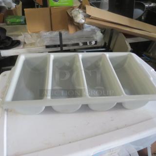 Four-compartment plastic flatware holder, white, used condition. Ideal for utensil organization in kitchens.