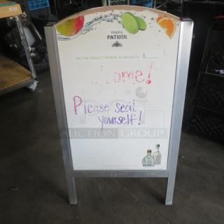 Patrón sidewalk sign with metal frame, colorful fruit design, worn condition, handwritten message, ideal for outdoor advert.