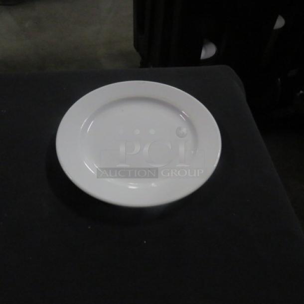 Royal Norfolk 7-inch white plate, 10XBID, on display. Simple design, appears in good condition.