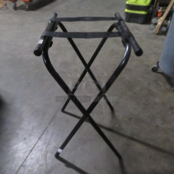 One Tray Stand, black metal frame, collapsible design, fabric straps on top, used condition, suitable for serving trays.