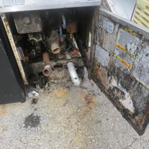 Pitco natural gas deep fryer with open panel showing internal components, two baskets, on casters, 16x35x46 inches, used condition.