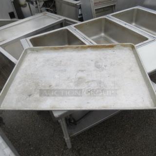 Full-size sheet pan, used condition, showing signs of wear and discoloration. Model 5XBID. Ideal for large-scale baking.