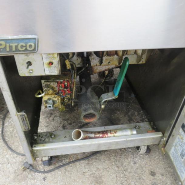 Pitco SG18 natural gas deep fryer with 2 baskets on casters, 19.5x34x44 inches. Used condition, visible wear.