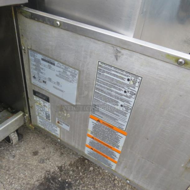 Pitco SG18 natural gas deep fryer with 2 baskets on casters. Labels with warnings and specifications visible.