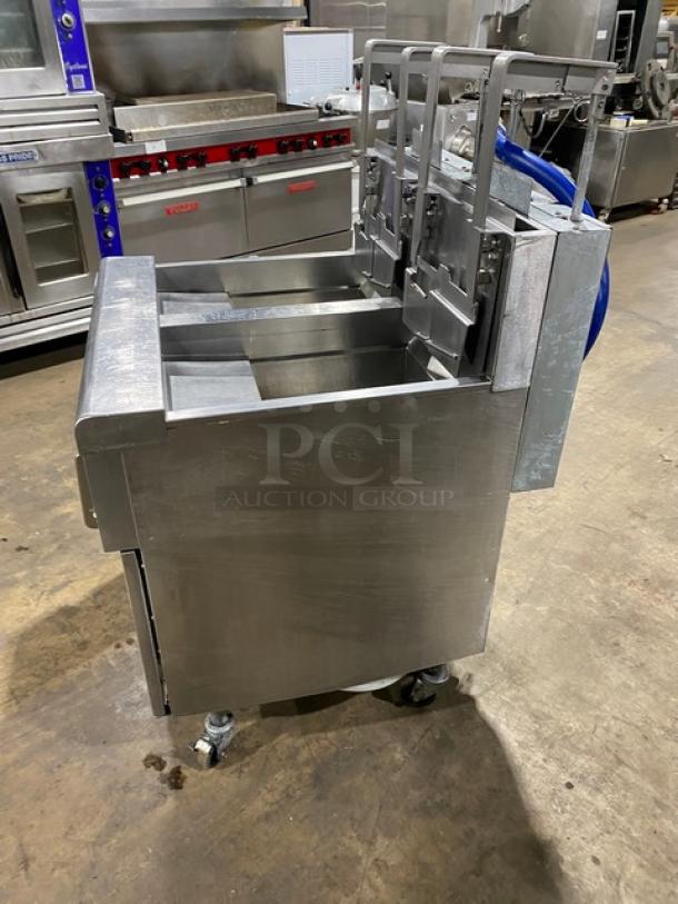 Frymaster stainless steel dual-tank deep fat fryer, model 2FQG30U0ZQTZBNG, with backsplash, basket hanger, on casters.