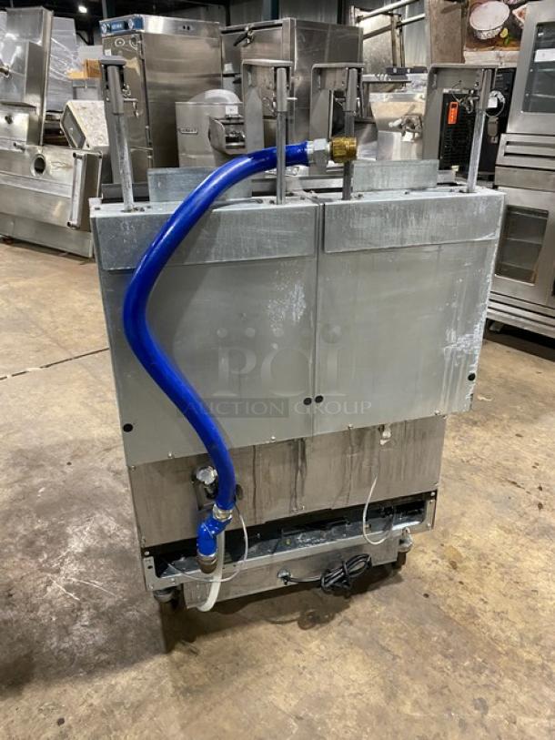 Frymaster dual-tank deep fat fryer, model 2FQG30U0ZQTZBNG, stainless steel, gas-powered, on casters, with backsplash and basket hanger.