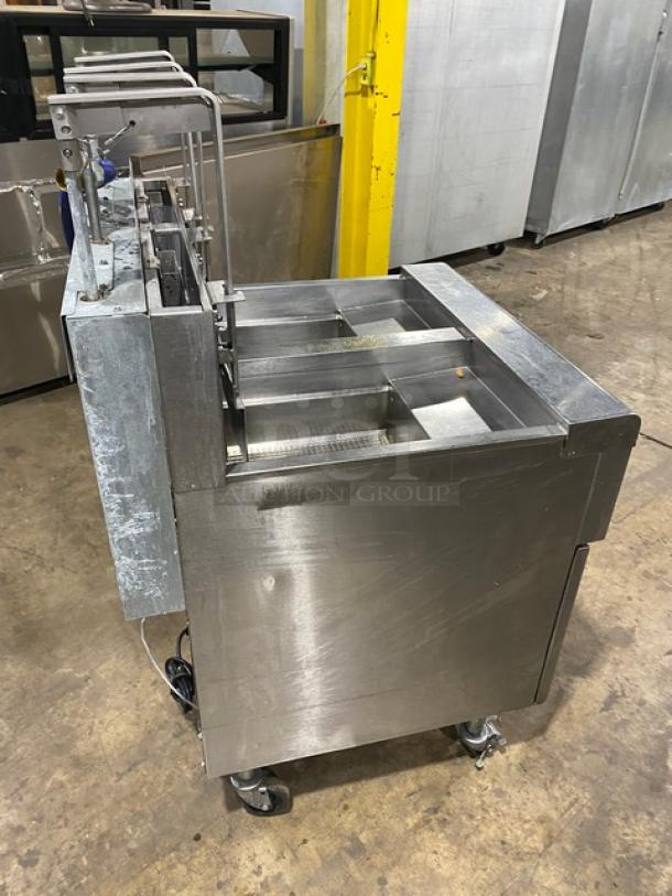 Frymaster dual-tank deep fat fryer, stainless steel, natural gas, with backsplash, basket hanger, model 2FQG30U0ZQTZBNG, on casters.