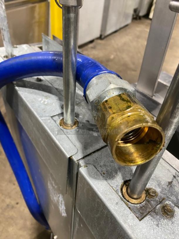Frymaster dual-tank deep fryer gas inlet with blue hose attached, stainless steel fittings, part of model 2FQG30U0ZQTZBNG.