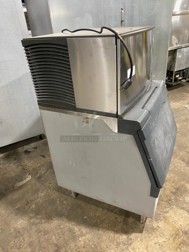 Manitowoc SD0303W stainless steel ice making machine with bin, water-cooled, 115V, 1 phase, on legs, electric powered.