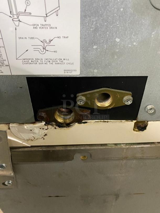 Manitowoc SD0303W ice machine connections, showing water inlet/outlet with installation diagram. Stainless steel panel.