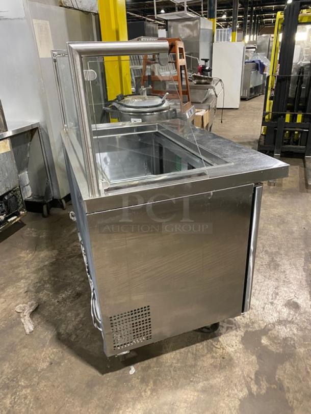 Atosa MSF8306 stainless steel 2-door refrigerated prep table with sneeze guard, poly-coated rack, on casters.