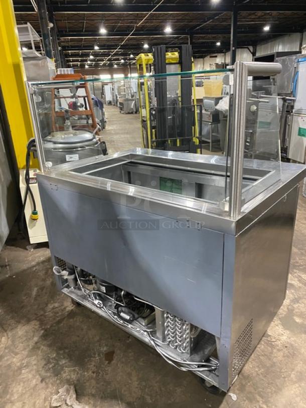 Atosa MSF8306 stainless steel 2-door refrigerated prep table with sneeze guard, poly-coated rack, 115V, on casters.