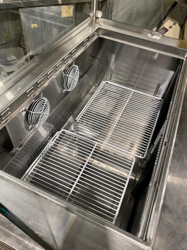 Atosa Model MSF8306 stainless steel 2-door refrigerated prep table with sneeze guard and poly-coated wire rack. In good condition.